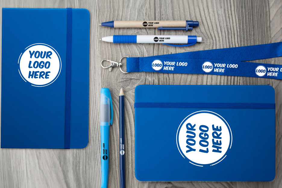 Assorted branded giveaways displayed on a booth table.