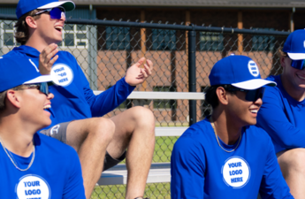 A group of men on bleachers wearing team performance apparel.